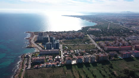 Seaside-resort-town-Spain-sunny-aerial-shot-mediterranean-sea-buildings-vacation